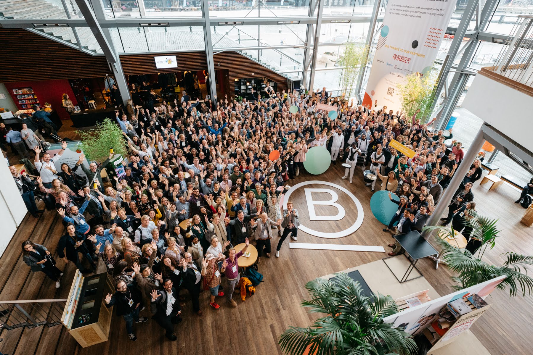 People from the B Corp movement standing around a large B written onto the floor